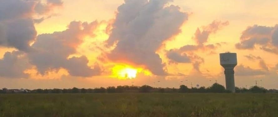 Sunset over the field by the Lockhart water tower